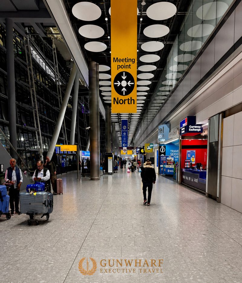 Heathrow Terminal 5 arrivals meeting point beneath Meeting Point North near the orange lifts. Heathrow chauffeur meet and greet collection point for airport transfers and Southampton cruise transfers.