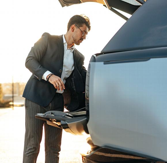 man loading luggage in car