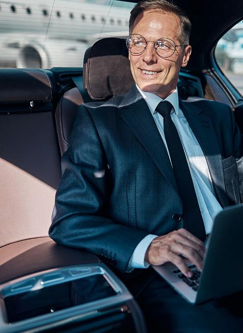 Business man in back of car