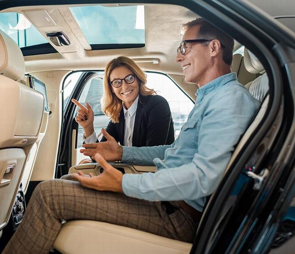 couple in back of car talking